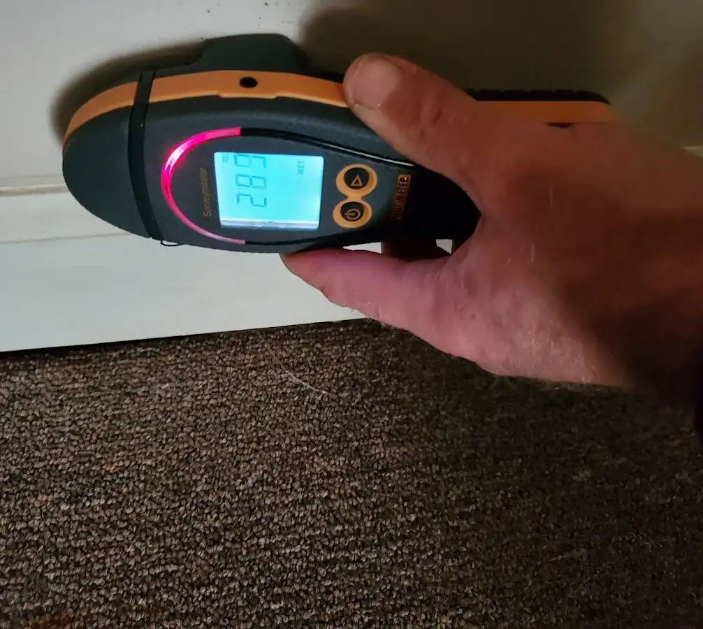 Moisture detection at baseboard during Storm Damage Restoration in Arnold